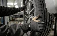 a man working on a tire in a garage